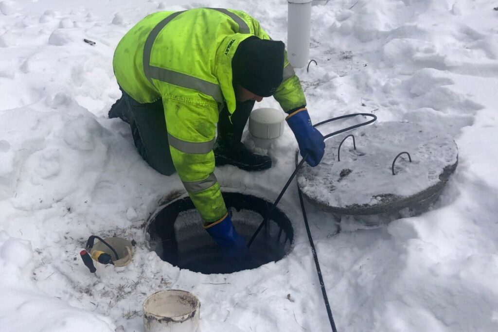 septic contractors checking septic tank in winter season